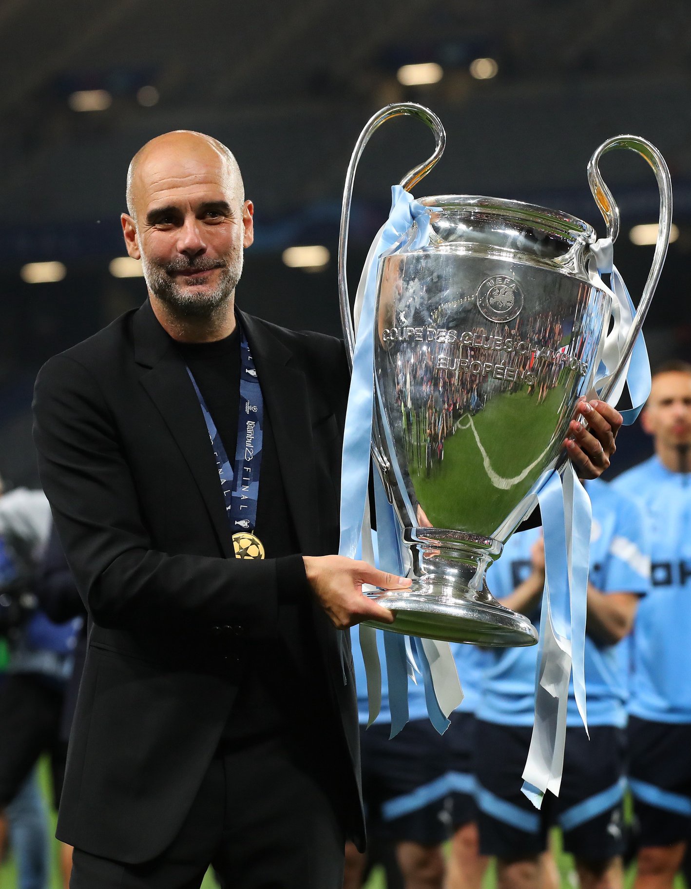 Pep Guardiola holds the Champions League trophy as Manchester City manager