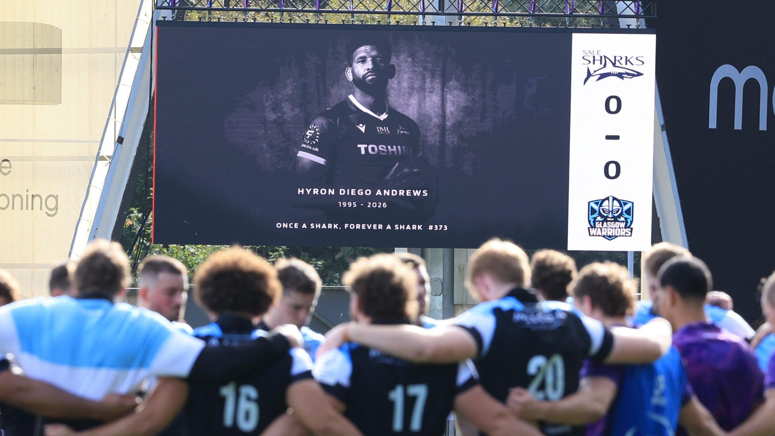 A tribute to Hyron Andrews is shown on a big screen at Sale's match with Glasgow