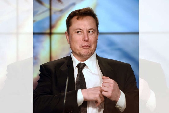Elon Musk wearing a suit and tie