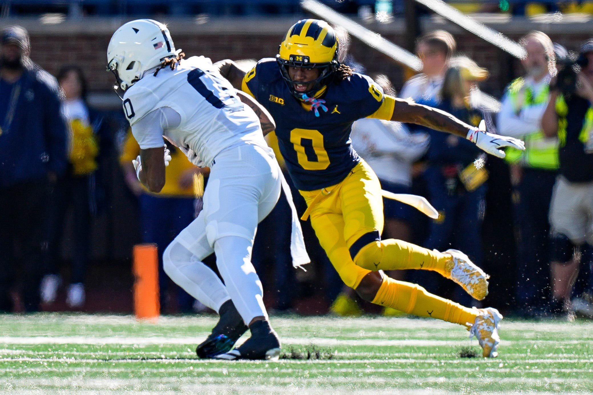 Michigan cornerback Jyaire Hill (0) tackles Penn State wide receiver Chase Sowell (0) during the first half at Michigan Stadium in Ann Arbor on Saturday, Oct. 17, 2026.