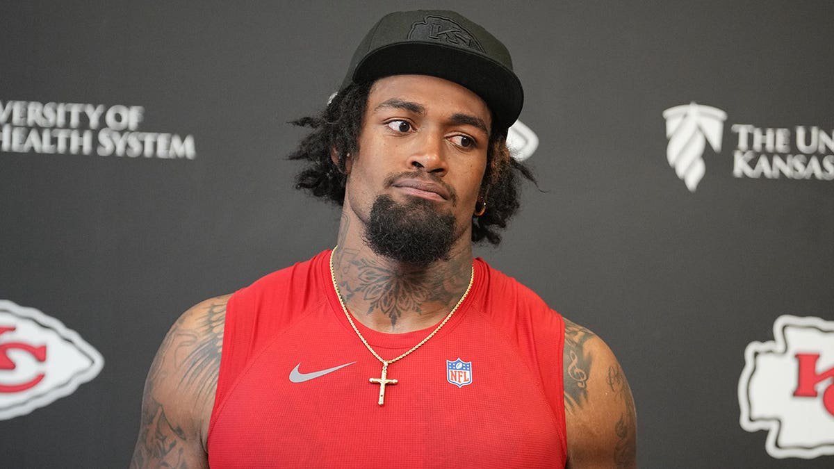 Josh Simmons speaks to media members during a press conference.