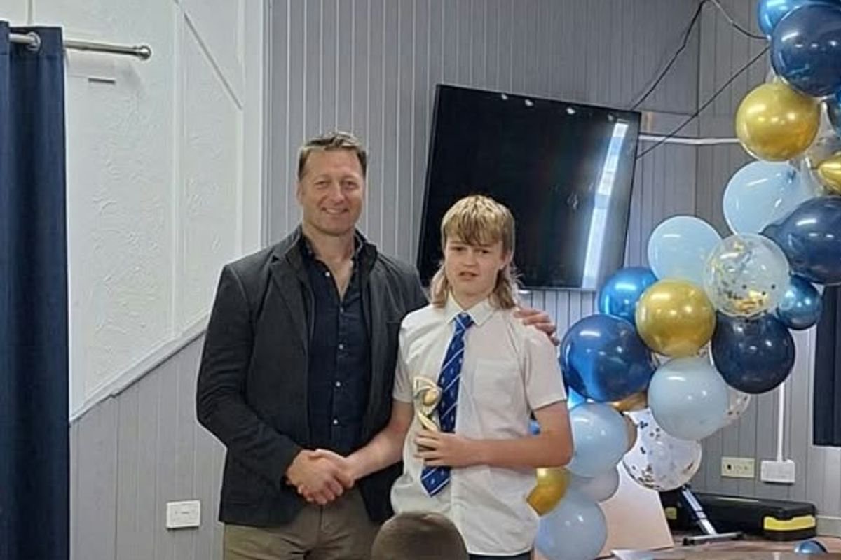 Luc Evans receives his player of the year award from Ian Gough in 2024