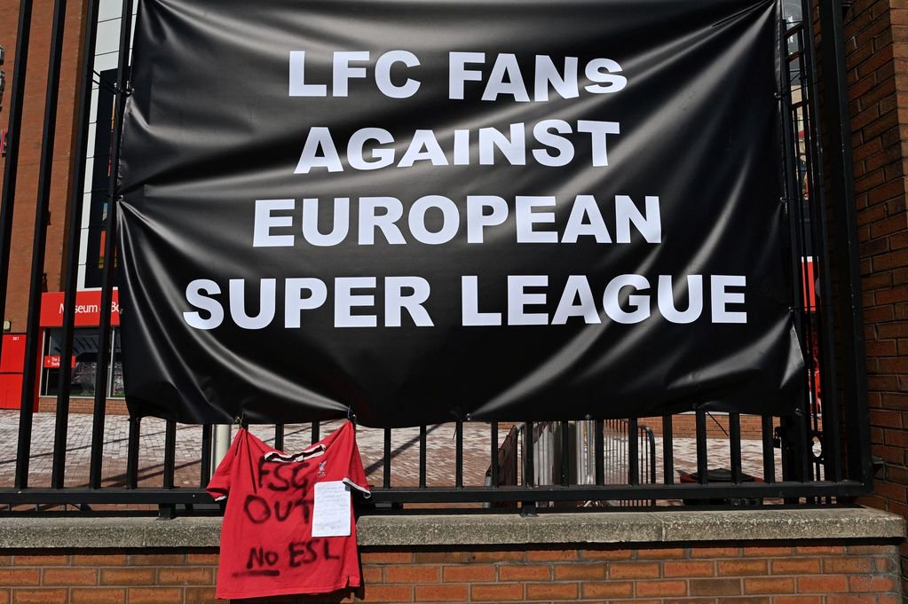 Anti-European Super League posters hang outside Anfield stadium, home of English Premier League football club Liverpool, in Liverpool, north west England on April 19, 2021. - Fan of the six Premier League clubs leading the breakaway European Super League have slammed the controversial plan, branding it the "ultimate betrayal". Liverpool, Manchester United, Arsenal, Chelsea, Manchester City and Tottenham are all involved in the new league, alongside Spanish trio Real Madrid, Barcelona, Atletico Madrid and Italian clubs Juventus, Inter Milan and AC Milan. 