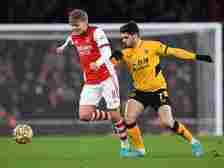 Martin Odegaard of Arsenal takes on Pedro Neto of Wolves during the Premier League match between Arsenal and Wolverhampton Wanderers at Emirates St...