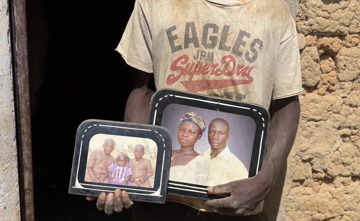 Armak Isa holds the picture of his brother’s family killed in Kambar Pelli, Bokkos LGA, Plateau State on Christmas Eve of 2023. (PHOTO CREDIT: Qosim Suleiman/Premium Times)