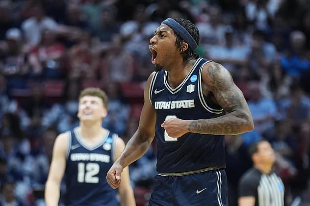 FILE - Utah State guard MJ Collins, who has since transferred to Cincinnati, celebrates during the second half in the first round of the NCAA college basketball tournament against Villanova, Friday, March 20, 2026, in San Diego. (AP Photo/Marcio Jose Sanchez, File)