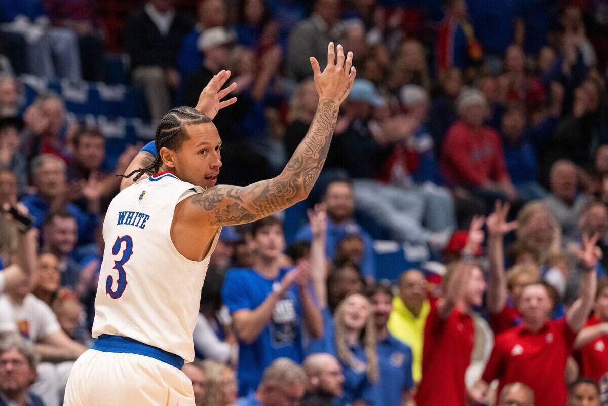 Kansas Jayhawks guard Tre White throws his hands up after hitting a three pointer in the Jayhawks exhibition game vs. Pittsburg State Gorillas, on Friday, October 16, 2026, at Allen Fieldhouse. The exhibition game, a first for Late Night in the Phog, replaces the normal format of variety show style sketches and a team scrimmage.