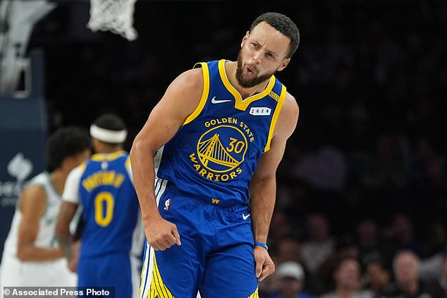 Golden State Warriors guard Stephen Curry (30) celebrates after making a 3-point shot during the first half of an NBA basketball game against the Minnesota Timberwolves, Wednesday, Oct. 28, 2026, in Minneapolis. (AP Photo/Abbie Parr)