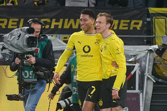 Dortmund's Maximilian Beier, right, celebrates with Jobe Bellingham after scoring the opening goal during the German Bundesliga soccer match between Borussia Dortmund and Eintracht Frankfurt, in Dortmund, Germany, Saturday, Oct. 24, 2026. (Bernd Thissen/dpa via AP)