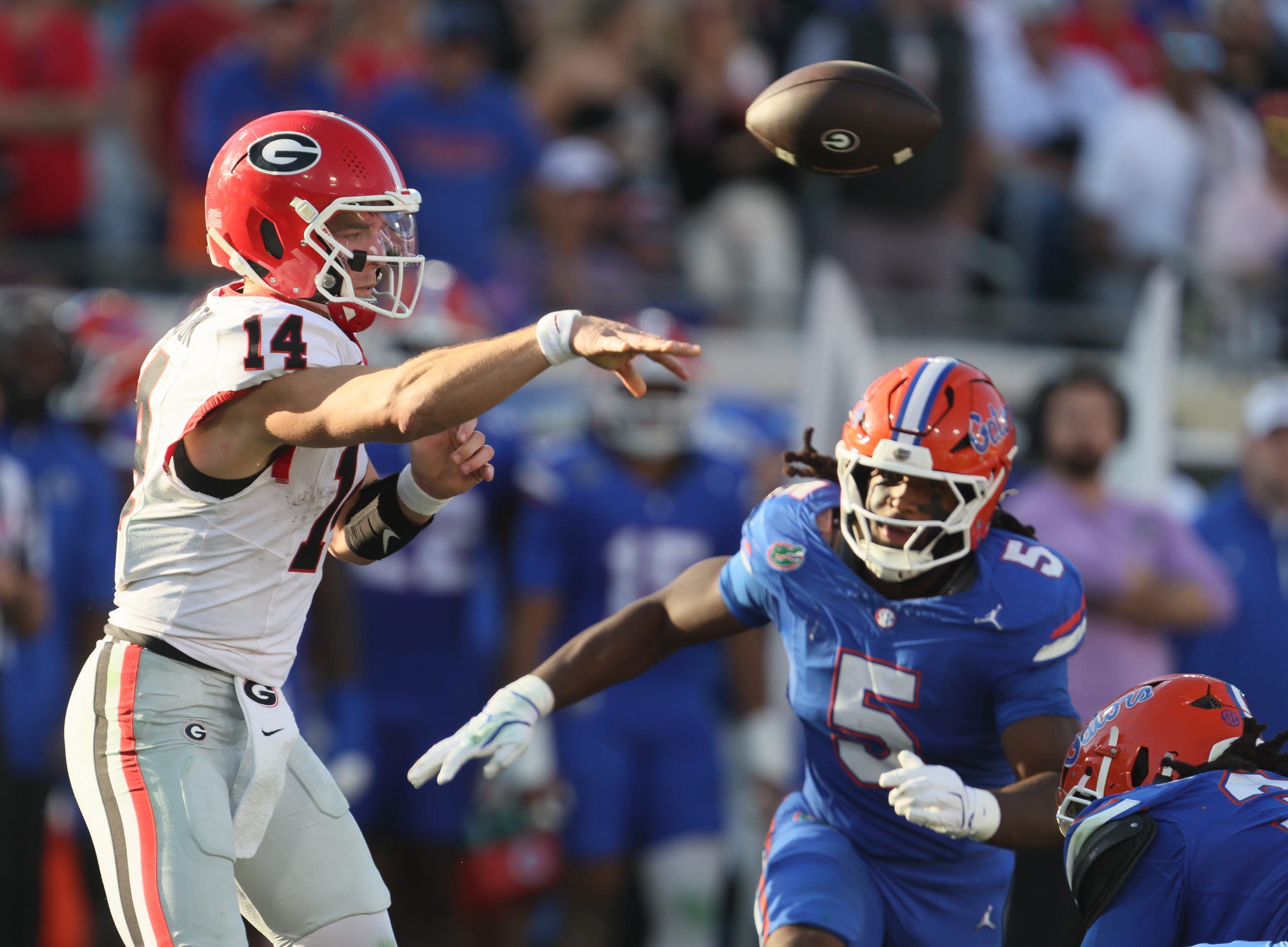 Gunner Stockton (14) passes under pressure from Florida Gators linebacker Myles Graham (5) during the first half of an NCAA football game at Everbank Stadium in Jacksonville, FL on Saturday, November 1, 2025.