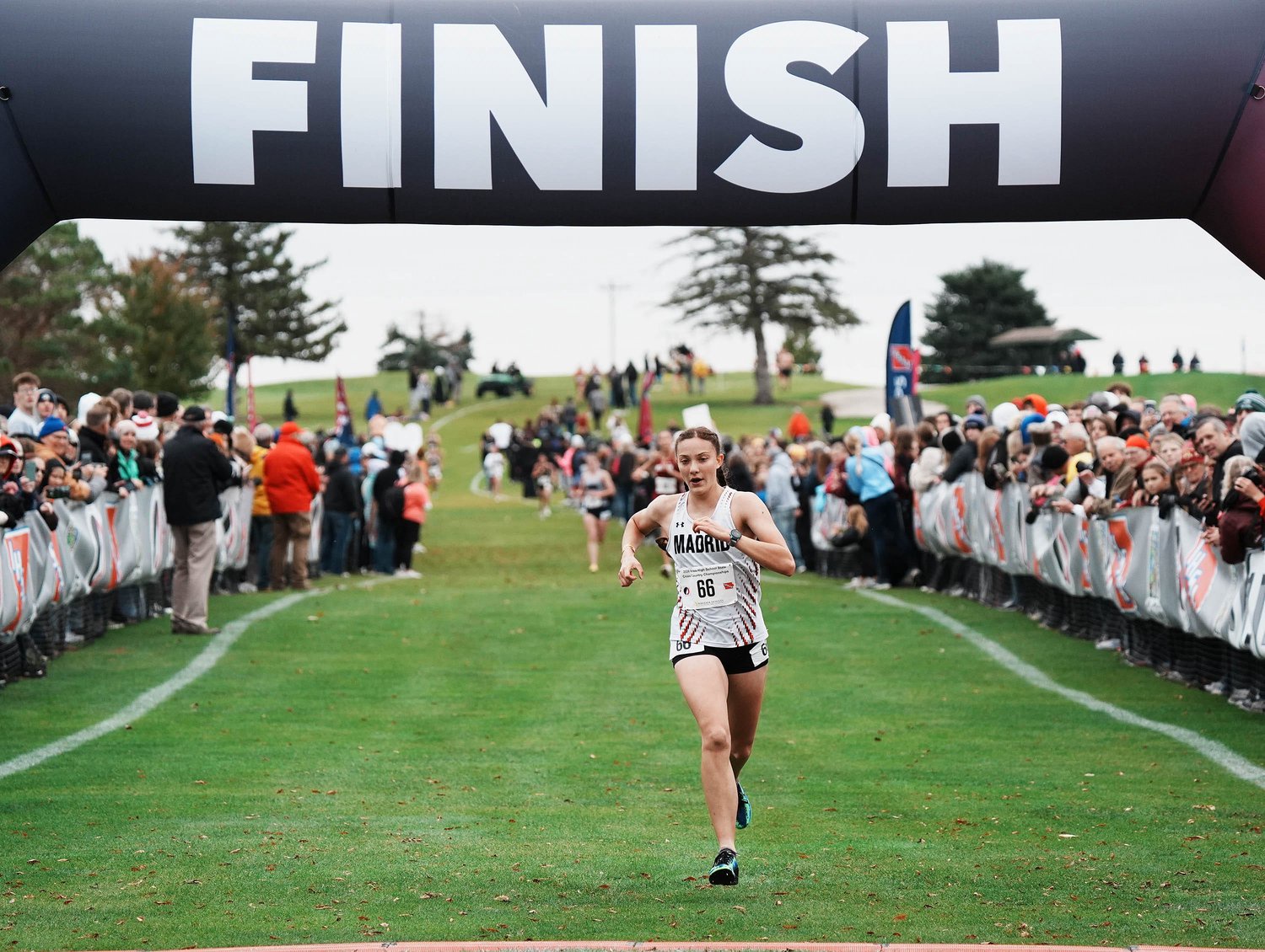 Madrid's Madelyn Grothus (66) finishes the race during the Class 1A girls state cross country meet at Lakeside Municipal Golf Course on Oct. 30, 2026, in Fort Dodge, Iowa. Grothus won the individual title.