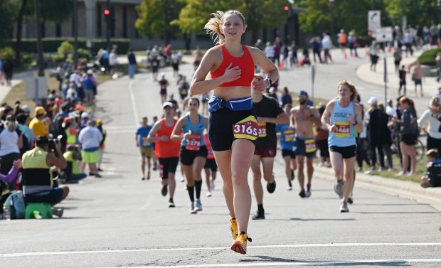 A runner smiles as she runs on Summit Avenue.
