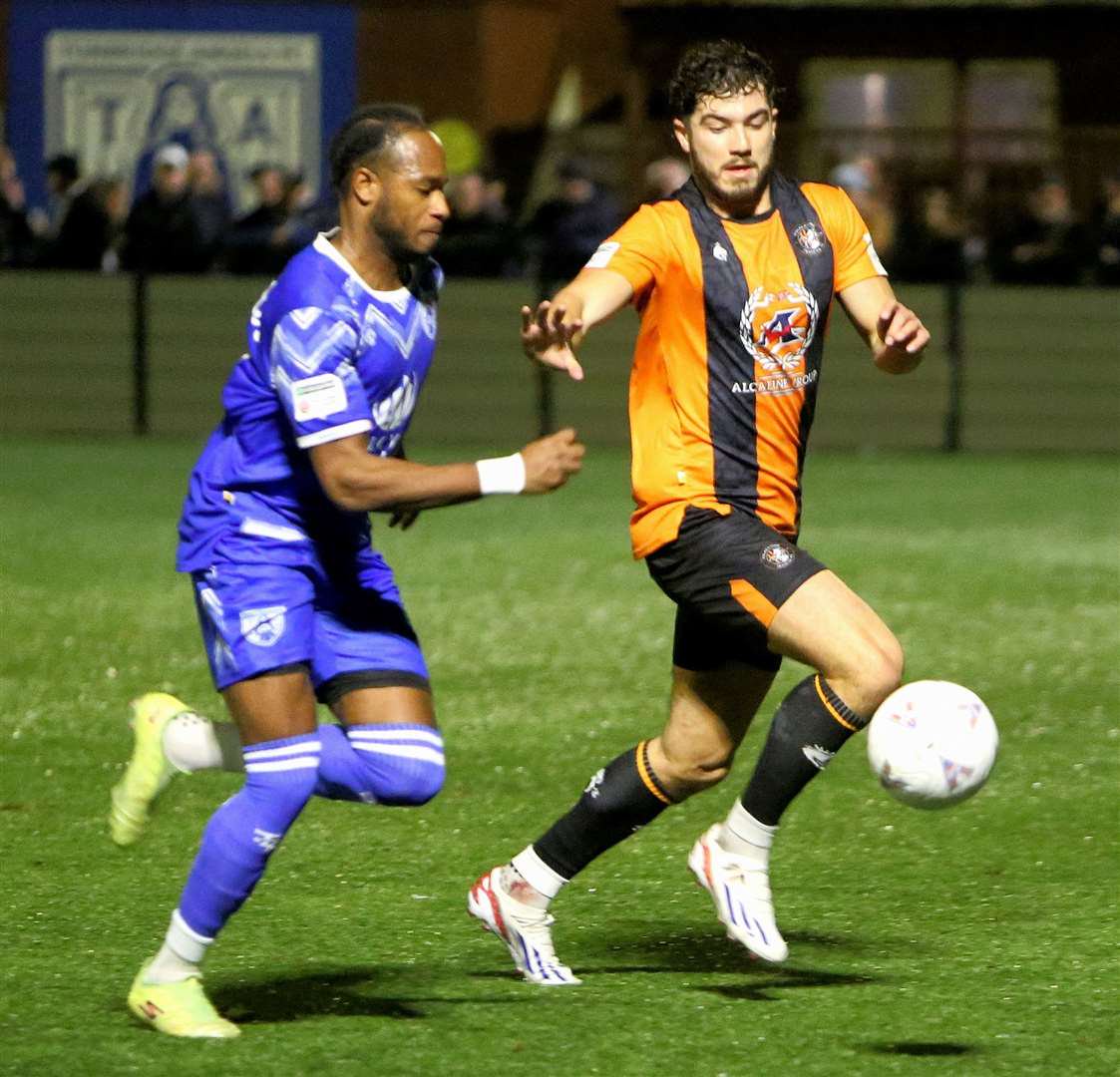 Jamie Fielding keeps tabs on Tonbridge forward Lamar Reynolds before injury ended his match early. Picture: David Couldridge