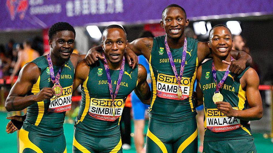 Gold medallists Bradley Nkoana (left), Akani Simbine (second left), Sinesipho Dambile (second right) and Bayanda Walaza (right) line up to pose for a photo with medals after winning the men's 4x100m relay final during the 2025 World Relays in Guangzhou. 