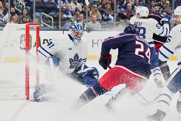 Toronto Maple Leafs goaltender Anthony Stolarz (41) blocks a shot by Columbus Blue Jackets right wing Mathieu Olivier (24) in the second period of an NHL hockey game in Columbus, Ohio, Tuesday, October. 20, 2026. (AP Photo/Sue Ogrocki)