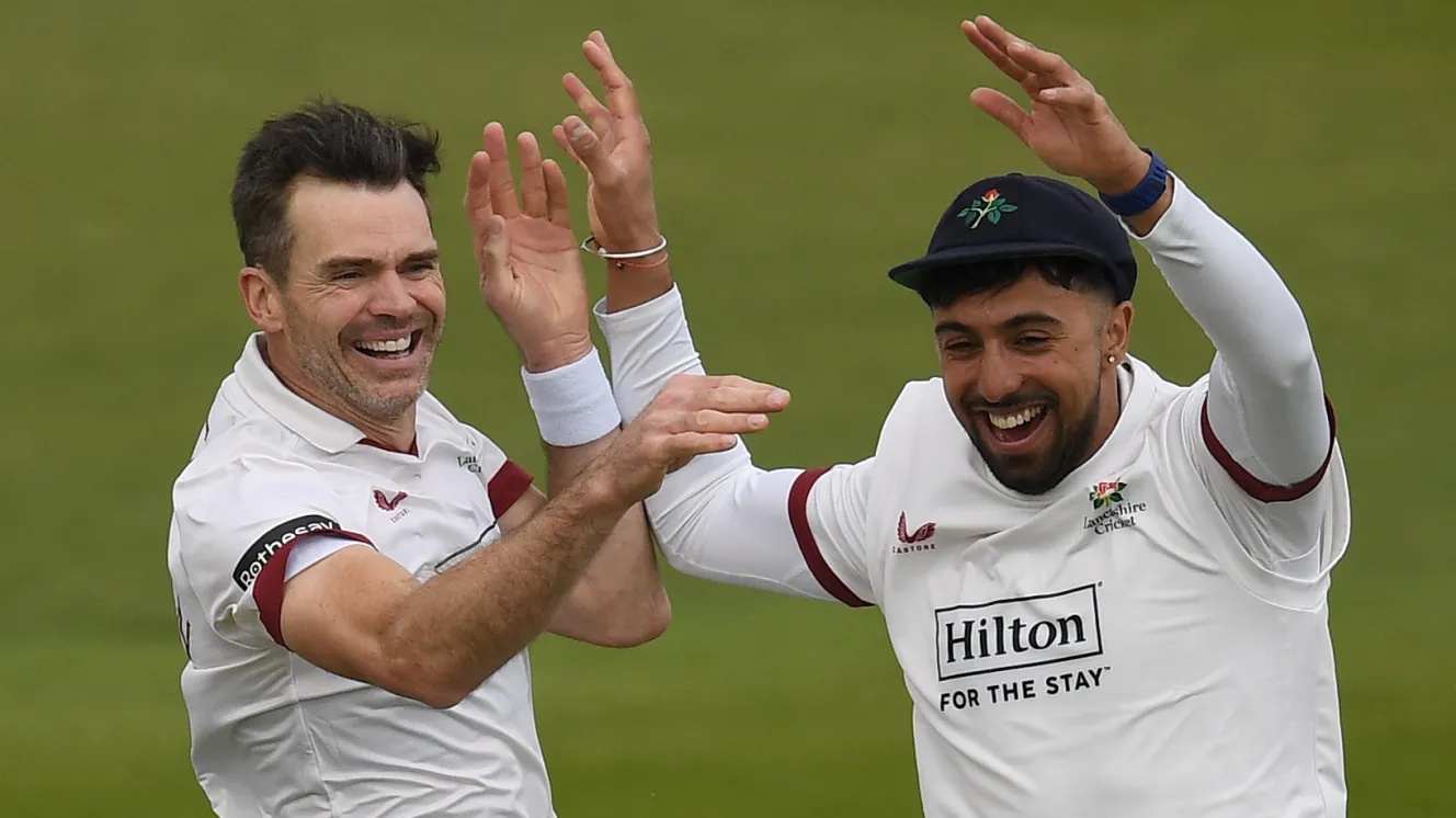 James Anderson (left) and Ajeet Singh Dale celebrate dismissing James Sales during a cricket match.