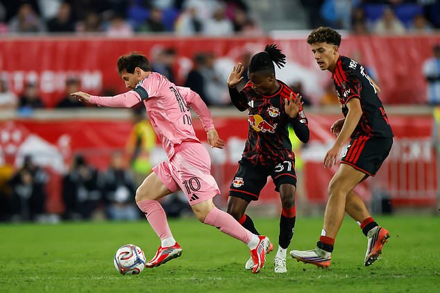 Inter Miami forward Lionel Messi, left, dribbles as New York Red Bulls forward Mohammed Sofo, center, and Adri Mehmeti defend during an MLS soccer match Saturday, Oct. 24, 2026, in Harrison, N.J. (AP Photo/Eduardo Munoz Alvarez)