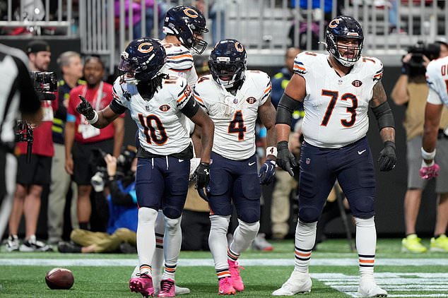 Chicago Bears running back D'Andre Swift (4) celebrates with Luther Burden III (10) and Jonah Jackson (73) after Swift scored his second touchdown against the Atlanta Falcons during the first half of an NFL football game in Atlanta, Sunday, Oct. 18, 2026. (AP Photo/Brynn Anderson)