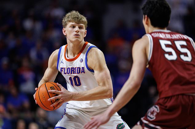 FILE - Florida forward Thomas Haugh (10) looks to pass as South Carolina guard Mike Sharavjamts (55) defends during the second half of an NCAA college basketball game, Feb. 17, 2026, in Gainesville, Fla. (AP Photo/Chris Watkins, File)