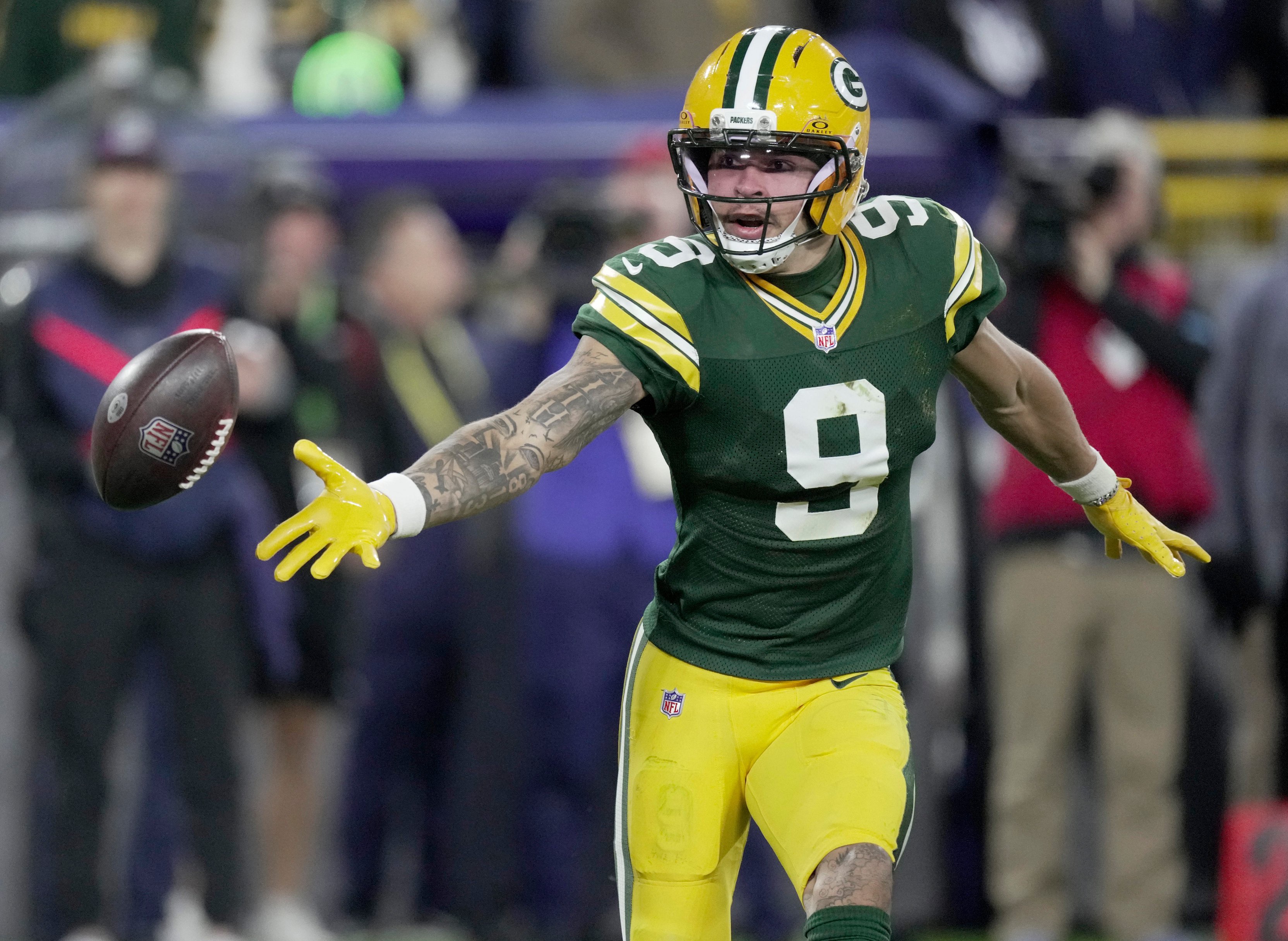 Green Bay Packers wide receiver Christian Watson (9) tosses the ball back to quarterback Jordan Love (10) on a trick play during the second quarter of their game against the Dallas Cowboys Sunday, Oct. 18, 2026 at Lambeau Field in Green Bay, Wisconsin. 