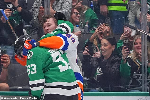 New York Islanders defenseman Matthew Schaefer (48) and Dallas Stars center Wyatt Johnston (53) tangle during the first period of an NHL hockey game Sunday, Oct. 25, 2026, in Dallas. (AP Photo/LM Otero)