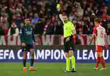 Gabriel Jesus is shown a yellow card by referee Danny Makkelie against Bayern Munich