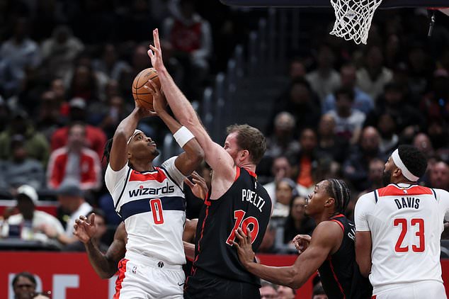 Washington Wizards guard Bilal Coulibaly (0) shoots as Toronto Raptors center Jakob Poeltl (19) defends during the first half of an NBA basketball game in Washington, Friday, Oct. 23, 2026. (AP Photo/Terrance Williams)