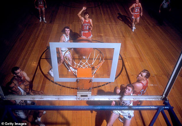 Cliff Hagan #16 of the St. Louis Hawks shoots a free-throw during an NBA game against the Cincinnati Royals on November 2, 1958 at the Cincinnati Gardens