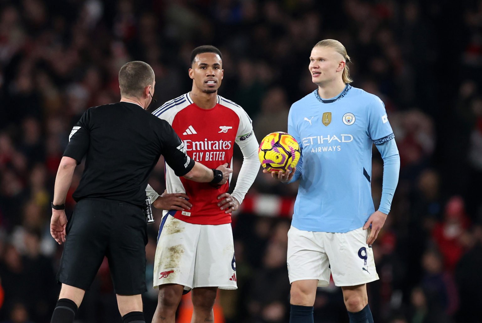 Referee Peter Bankes talks to Gabriel Magalhaes of Arsenal and Erling Haaland of Manchester City  during the Premier League match between Arsenal F...