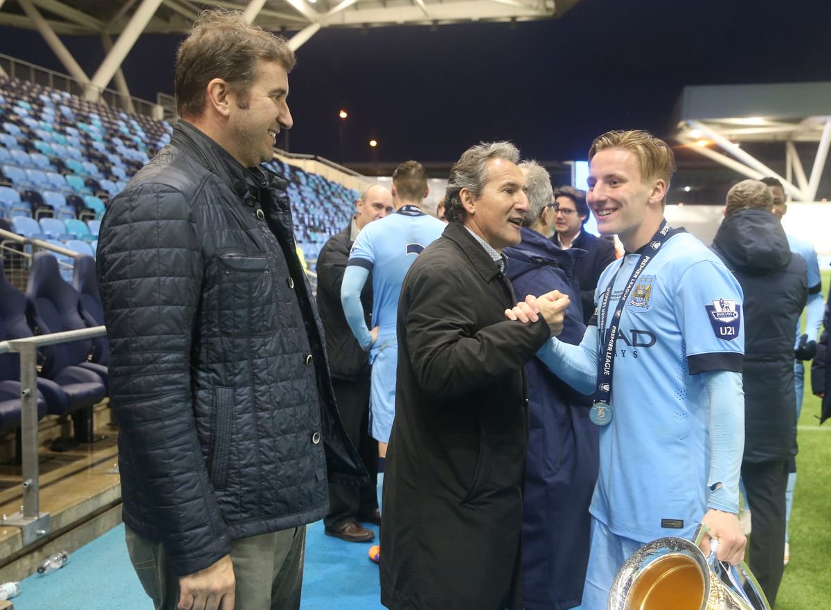 Manchester City's George Glendon is congratulated by Txiki Begiristain and Ferran Soriano