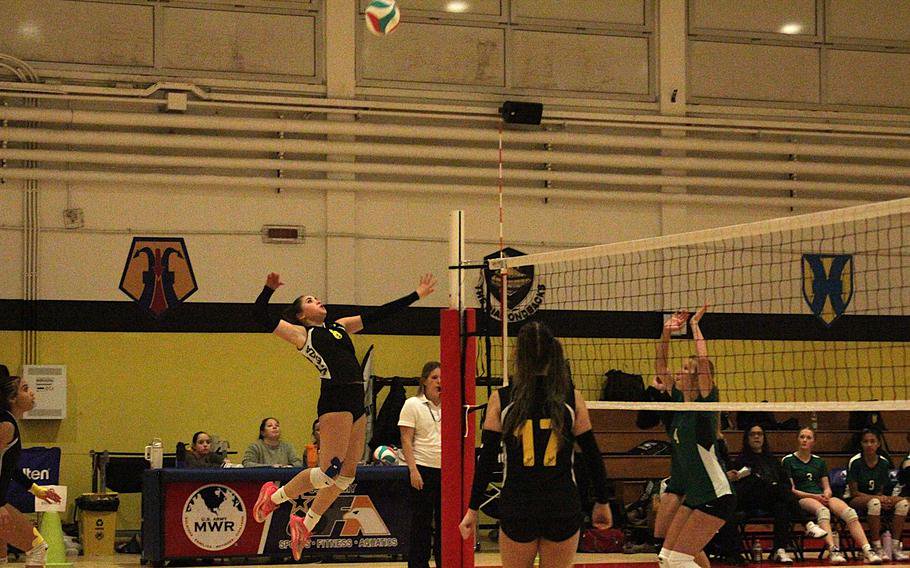 Vicenza girls’ volleyball team senior outside hitter Natalia Lopez eyes up the ball for a slap-down against Naples Wildcat sophomore middle blocker Addison Klawonn during a semifinal game of the 2026 DODEA-Europe volleyball championships Division II tournament at the Ederle Fitness Center gym on Caserma Ederle in Vicenza, Italy, on Friday, Oct. 30, 2026. 