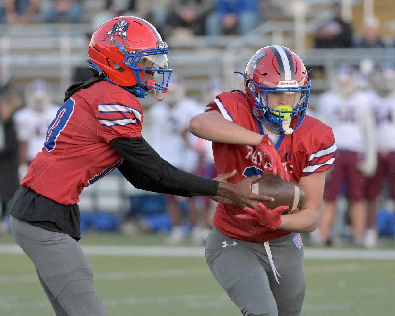 Old Mill Patriots Tyler McConville #22 takes a handoff from quarterback Edward Buck III #10 and runs for a touchdown in the first quarter. The Annapolis Panthers host the visiting Old Mill Patriots in a high school football held at Severna Park High School Friday evening. (Paul W. Gillespie/Staff)
