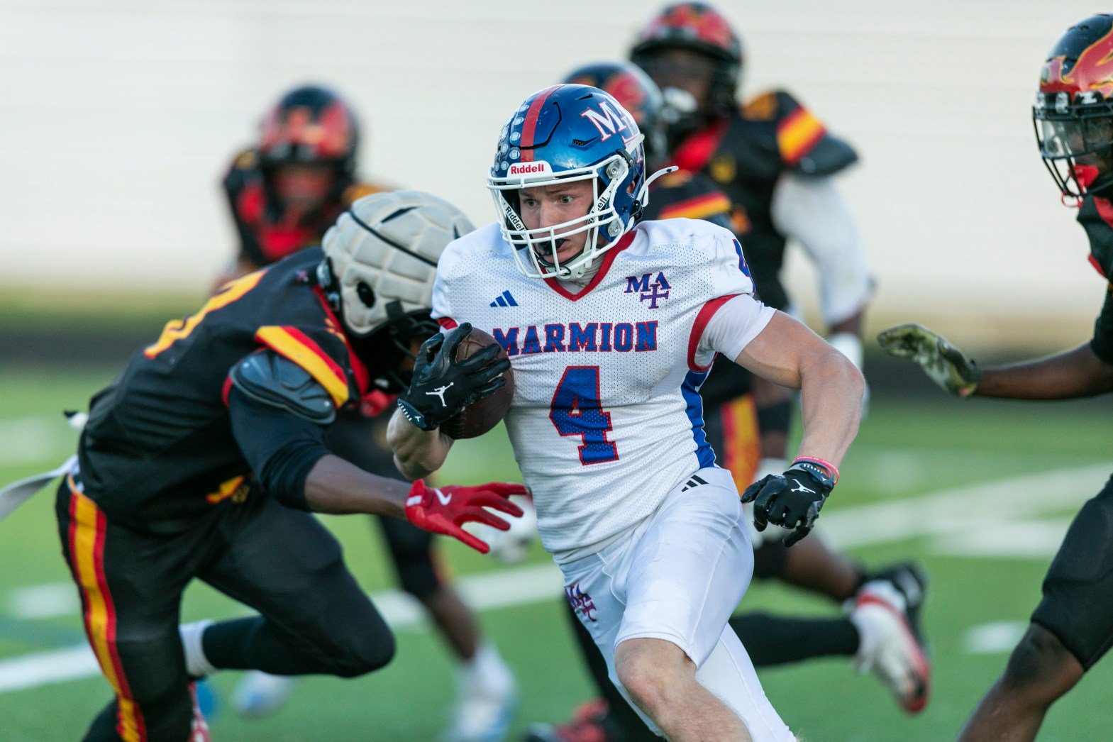 Marmion’s Henry Miller (4) slips past a would-be tackler against North Lawndale during a Class 4A opening-round playoff game in Chicago on Saturday, Oct. 24, 2026. (Vincent D. Johnson / The Beacon-News)