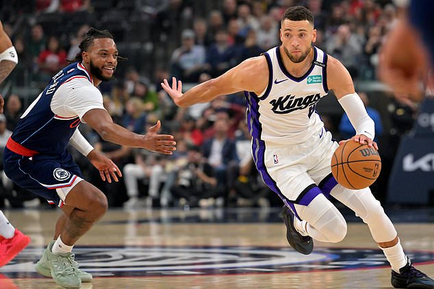 Sacramento Kings guard Zach LaVine (8) drives past Los Angeles Clippers guard Darius Garland during the first half of an NBA basketball game Wednesday, Oct. 21, 2026, in Los Angeles. (AP Photo/Jayne Kamin-Oncea)