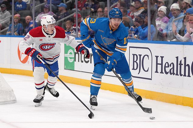 St. Louis Blues' Alexey Toropchenko (13) passes around Montreal Canadiens' Adam Engstrom (42) during the second period of an NHL hockey game Tuesday, Oct. 27, 2026, in St. Louis. (AP Photo/Jeff Roberson)