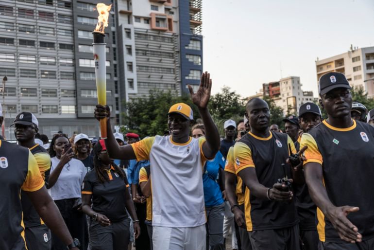 Senegal’s influencer and TikToker Khaby Lame carries the Youth Olympic Flame on the eve of the opening ceremony of the Youth Olympic Games in Dakar on October 30, 2026 [AFP]