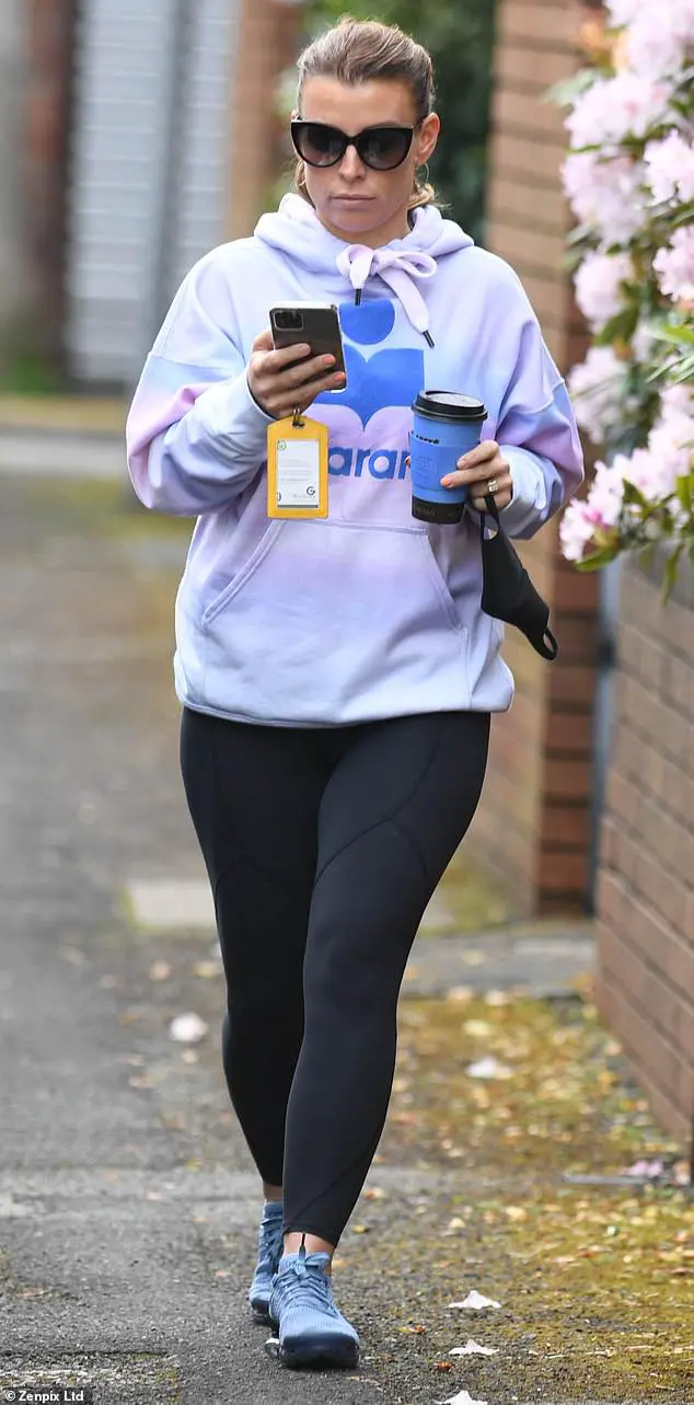 Coffee run: Coleen Rooney was seen getting back to her daily routine on Friday morning, when she stepped out solo for a coffee and snack in Alderley Edge, Cheshire