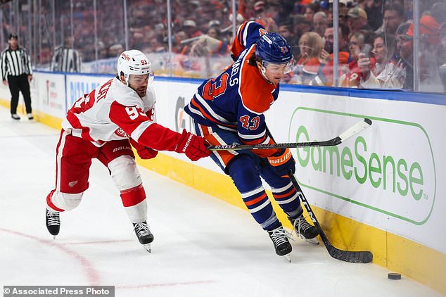 Edmonton Oilers' Owen Michaels (43) battles against Detroit Red Wings' Alex DeBrincat (93) during third period NHL hockey action in Edmonton, Alberta, Monday, Oct. 26, 2026. (Codie McLachlan/The Canadian Press via AP)