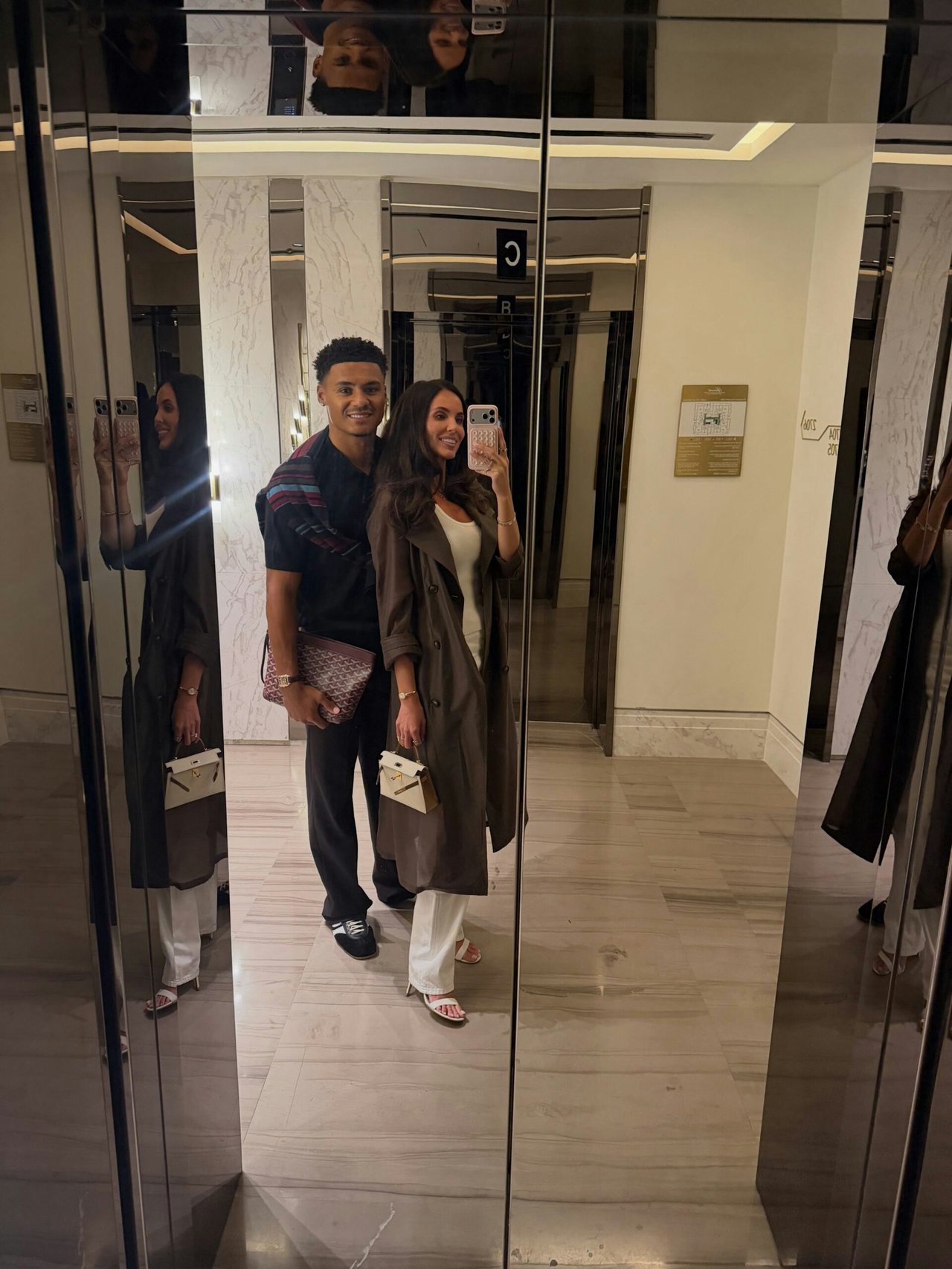 Ellie Watkins taking a selfie with her husband Olllie in a mirror