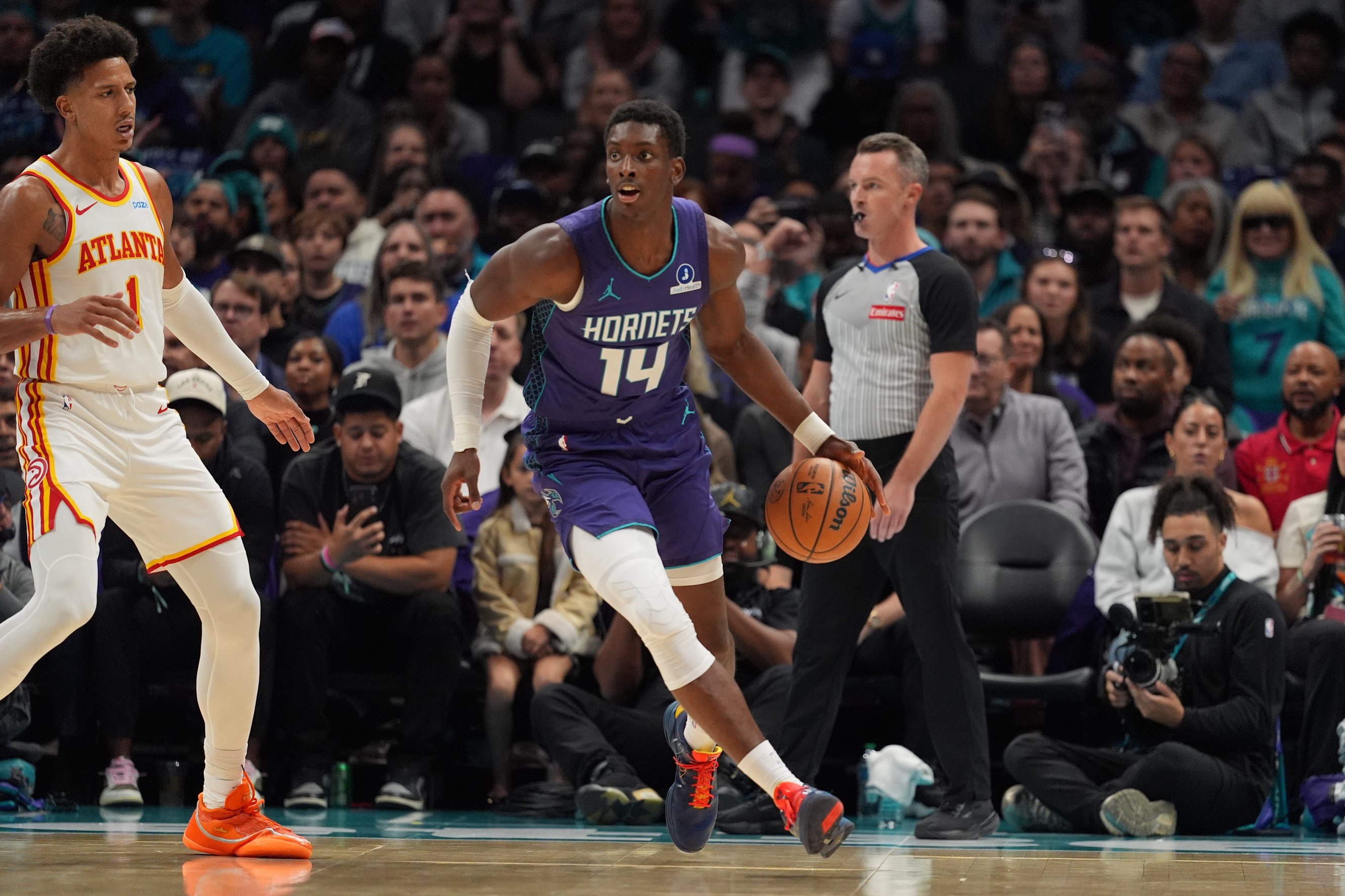 Oct 23, 2026; Charlotte, North Carolina, USA;  Charlotte Hornets forward Moussa Diabate (14) handles the rebound against Atlanta Hawks forward Jalen Johnson (1) during the first half at the Spectrum Center.  Mandatory Credit: Jim Dedmon-Imagn Images