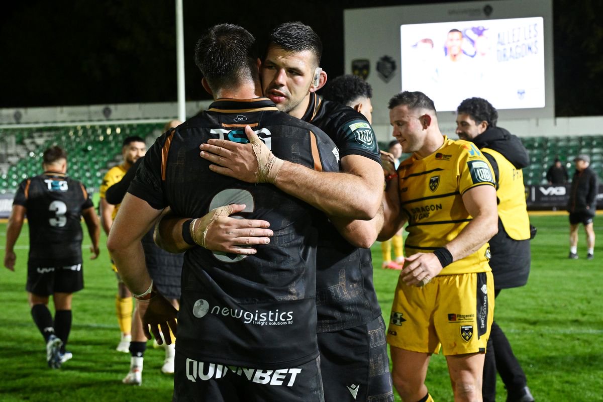 Liam Wright is embraced by Rhys Davies after his outstanding performance against the Dragons