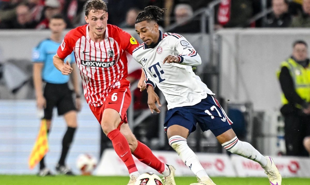 Bayern's Michael Olise, right, and Freiburg's Patrick Osterhage challenge for the ball during the German Bundesliga soccer match between SC Freiburg and FC Bayern Munich in Freiburg, Germany, Sunday, Oct. 25, 2026. (AP)
