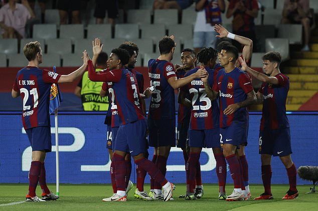 Barcelona players celebrate after Royal Antwerp's Jelle Bataille scored an own goal during the Champions League Group H soccer match between Barcelona and Royal Antwerp at the Olympic Stadium of Montjuic in Barcelona, Spain, Tuesday, Sept. 19, 2023. (AP Photo/Joan Monfort)