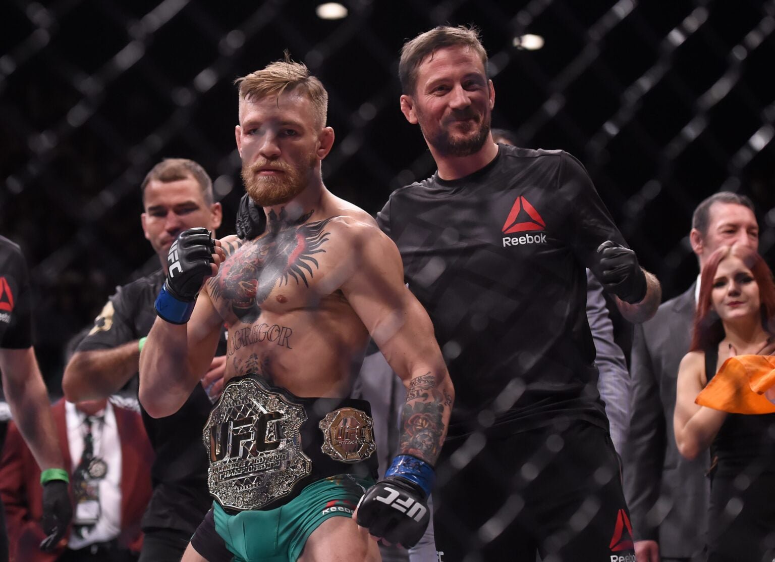 Conor McGregor and John Kavanagh pose in the Octagon following UFC 194 win