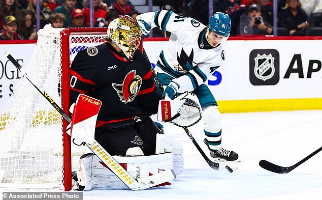 San Jose Sharks' Ivar Stenberg (41) looks to make a tip in front of Ottawa Senators goaltender Samuel Ersson, left, during the first period of an NHL hockey game in Ottawa, Ontario, Thursday, Oct. 22, 2026. (Keito Newman/The Canadian Press via AP)