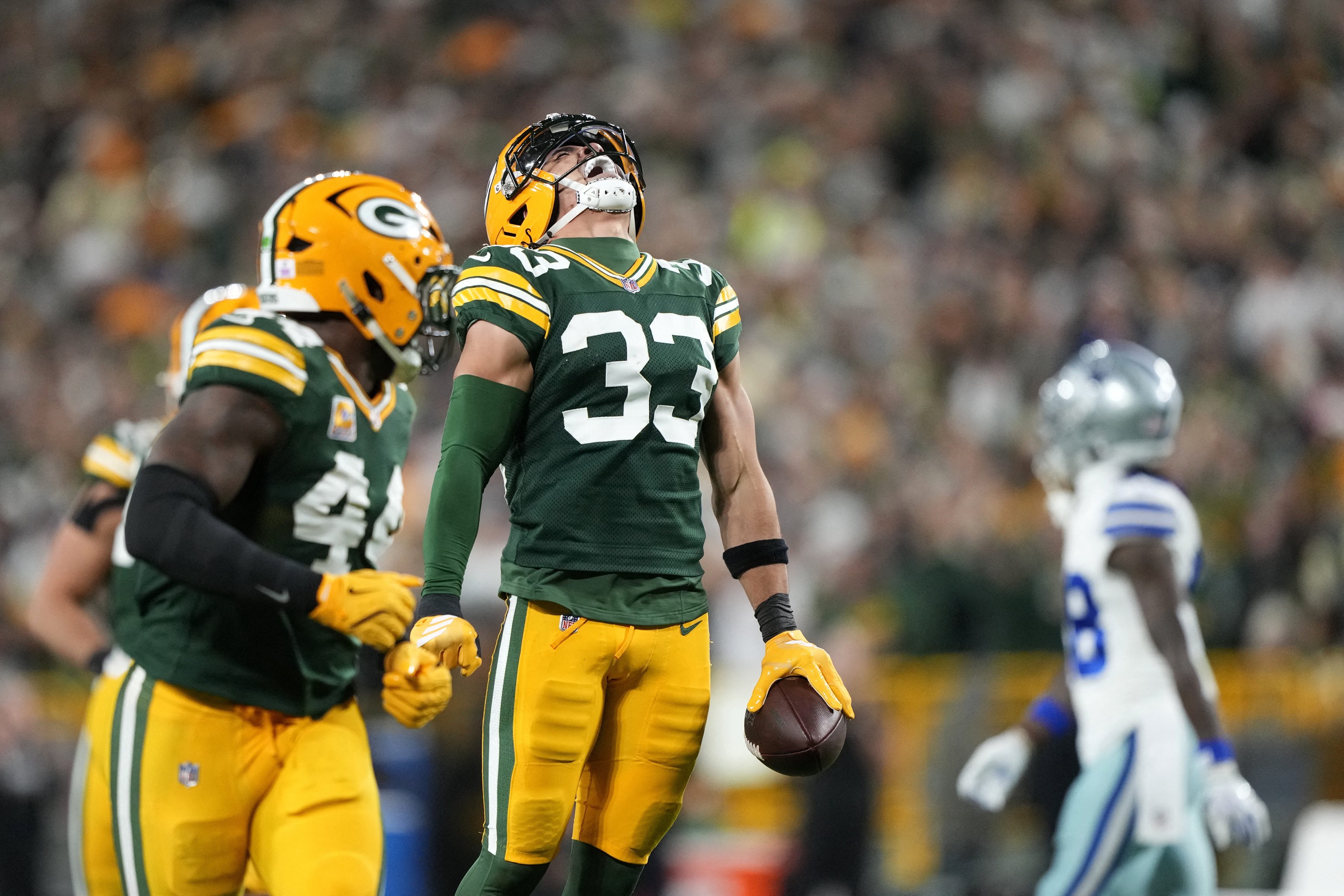 Oct 18, 2026; Green Bay, Wisconsin, USA;  Green Bay Packers safety Evan Williams (33) celebrates after making an interception against the Dallas Cowboys during the second quarter at Lambeau Field.  Mandatory Credit: Jeff Hanisch-Imagn Images