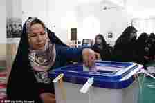 An Iranian woman casts her ballot at a polling station in Tehran on June 28. Many boycotted the vote on Friday, with critics branding the elections a 'sham'