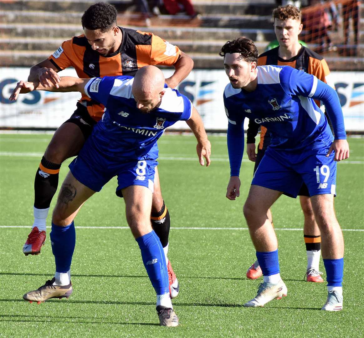 Reece Fleet, of AFC Totton, is challenged by Folkestone Invicta forward Aaron Cosgrave. Picture: Randolph File