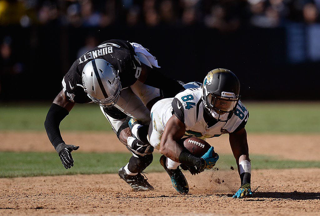 Cecil Shorts III of the Jacksonville Jaguars falls to the dirt portion of the football field at Oakland Alameda Stadium on Sept. 15, 2013, during a 19-9 loss to the Oakland Raiders. The Raiders were still sharing the field with the Oakland Athletics baseball team at the time of the game.