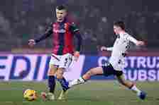 Stefan Posch of Bologna FC passes the ball whilst under pressure from Morten Frendrup of Genoa CFC during the Serie A TIM match between Bologna FC ...